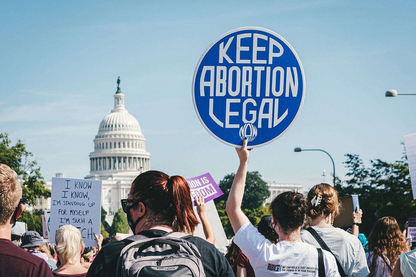 A protestor holding up a "Keep Abortion Legal" sign A protestor holding up a "Keep Abortion Legal" sign