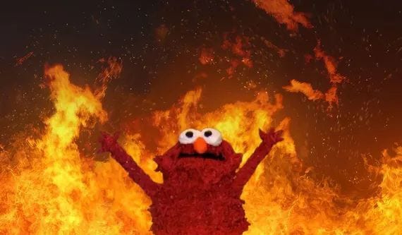 This may contain: the sesame street character is standing in front of a fire with his hands up and eyes wide open This may contain: the sesame street character is standing in front of a fire with his hands up and eyes wide open