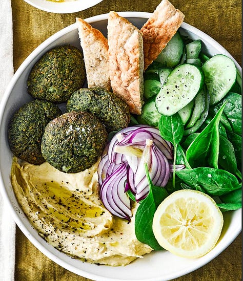 9 different plates of hummus with varying toppings from meatballs to lentils