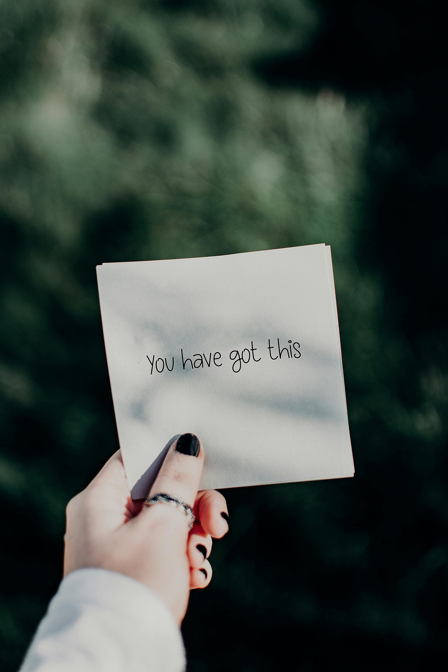 a hand holding a piece of paper with the words "you have got this"
