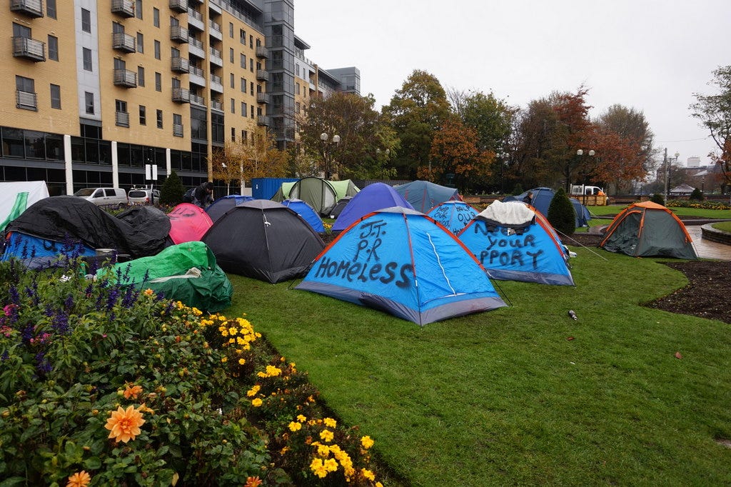 Homeless encampment in Hull, England, representing the impact of manufactured austerity on the UK economy. Homeless encampment in Hull, England, representing the impact of manufactured austerity on the UK economy.