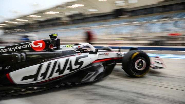 This tracking shot barely has the car in focus, the grandstands beyond are a blur. This tracking shot barely has the car in focus, the grandstands beyond are a blur.