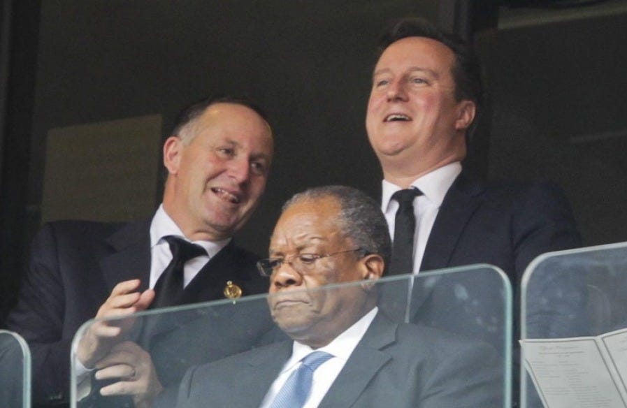 John Key and David Cameron share a joke at Nelson Mandela's funeral. John Key and David Cameron share a joke at Nelson Mandela's funeral.