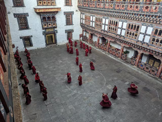 <p>Dancing monks beckon at Gangtey Monastery </p>