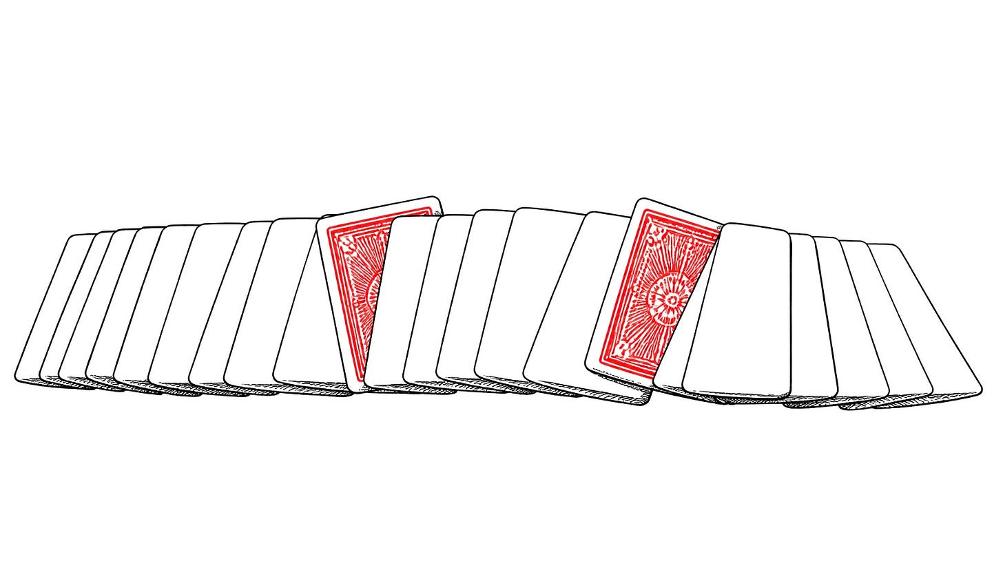 A wide fan of blank face-down cards with two red ones tucked among them. A wide fan of blank face-down cards with two red ones tucked among them.