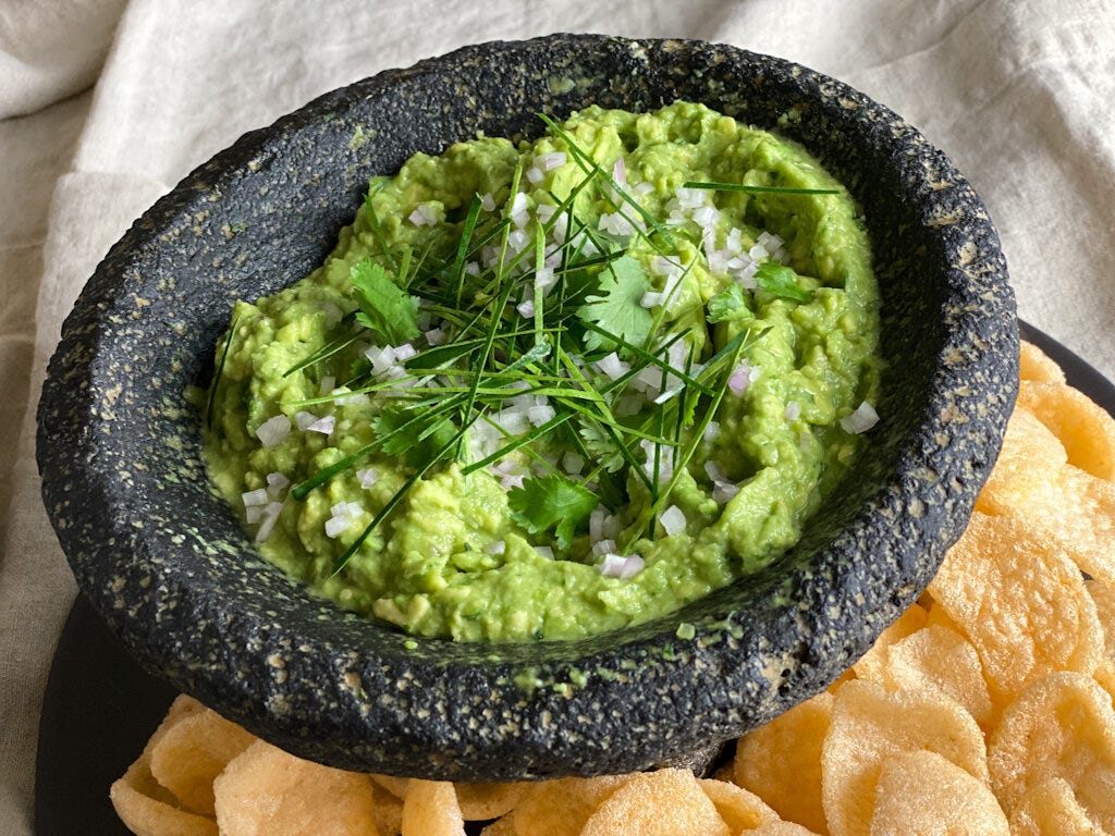 Bangkok Guac, flavored with lemongrass, shallots, Thai chiles, fish sauce and lime and garnished with makrut lime leaves and cilantro, is weirdly fabulous — especially scooped up with a shrimp chip.