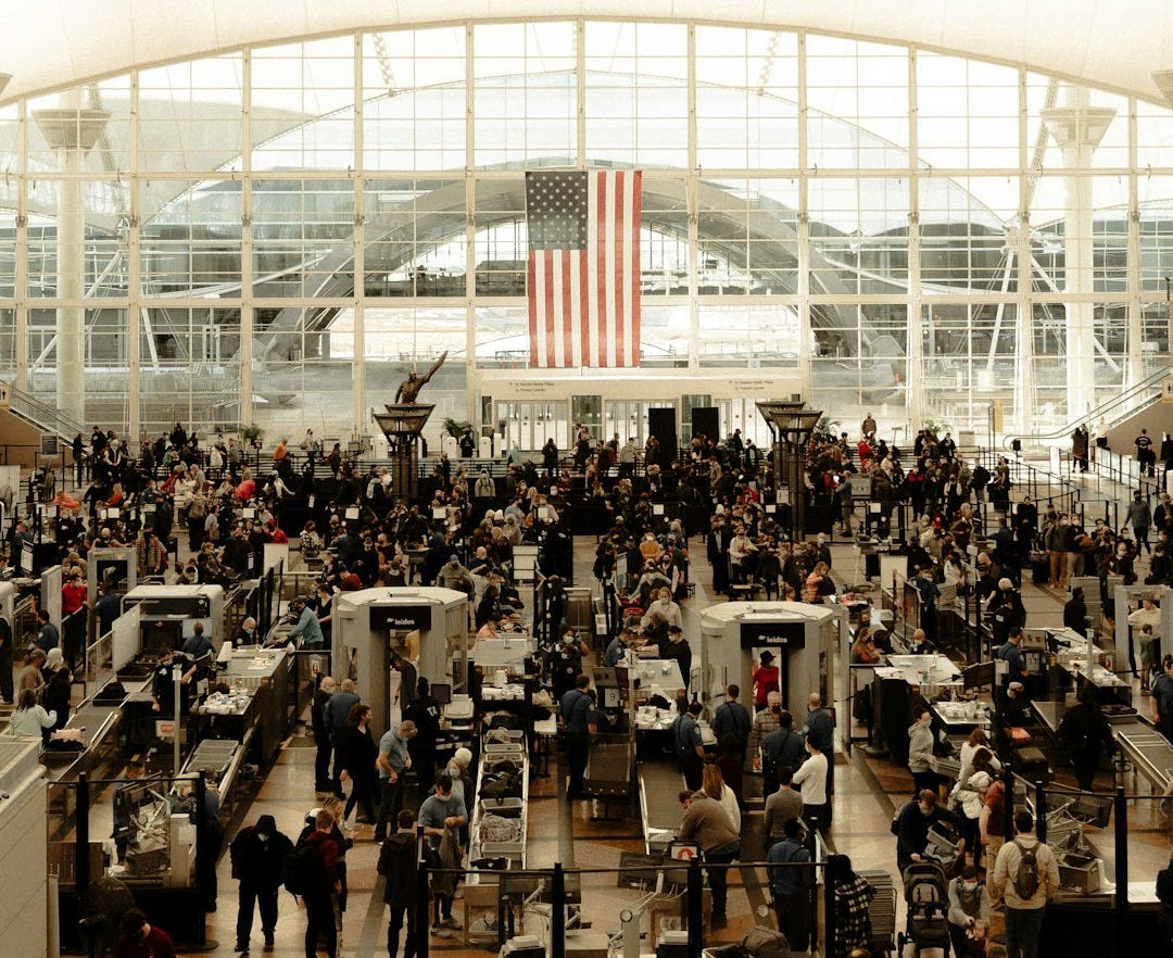 an airport filled with lots of people and luggage