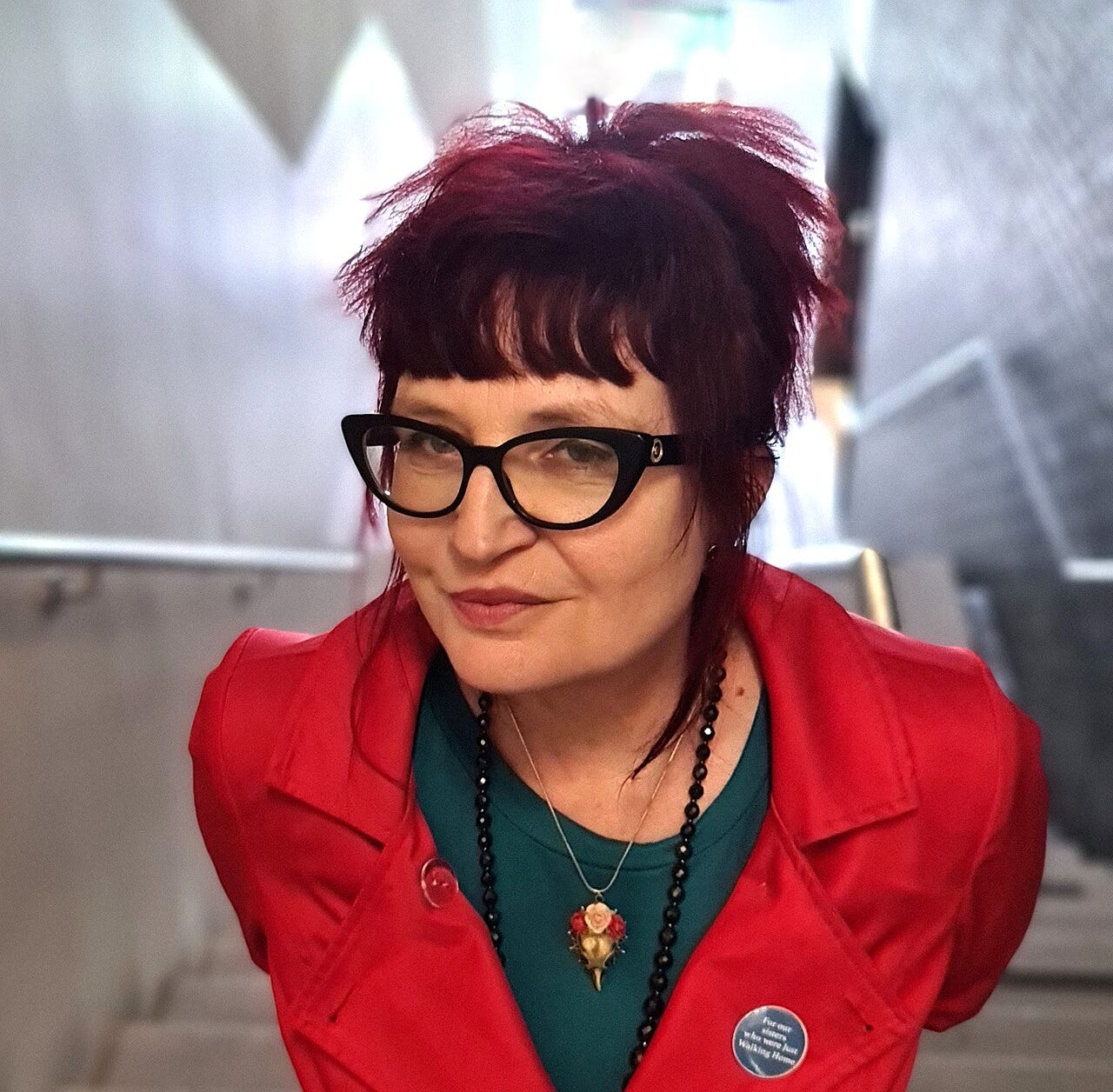 Photo of Helen Ivory wearing a red jacket.