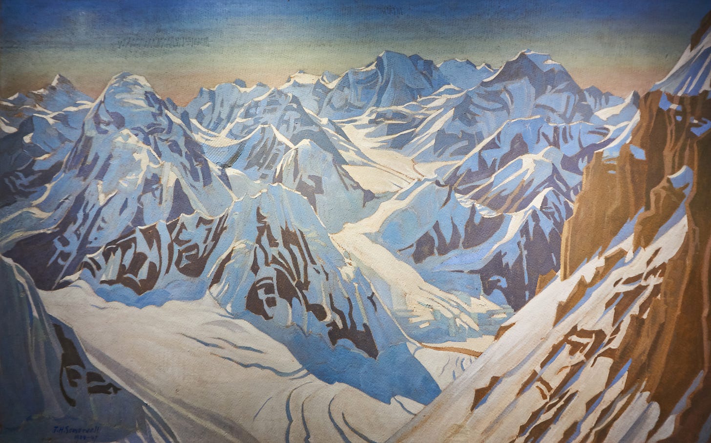 steep mountains of rock and snow above glaciers