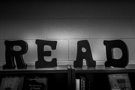 ceiling art, chessboard, sign in library that says "read," feng shui beads, artistic tree