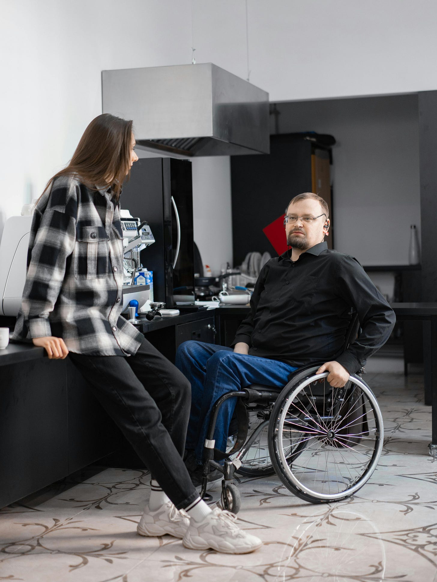 A Man in Black Long Sleeves Sitting on a Wheelchair