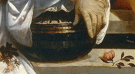 Close view of the closed silver casket resting on the rim of the fountain.