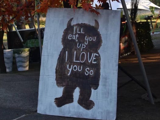 An image from Where the Wild Things Are. An outline of a monster with the words "I'll eat you up I love you so" written in white within.