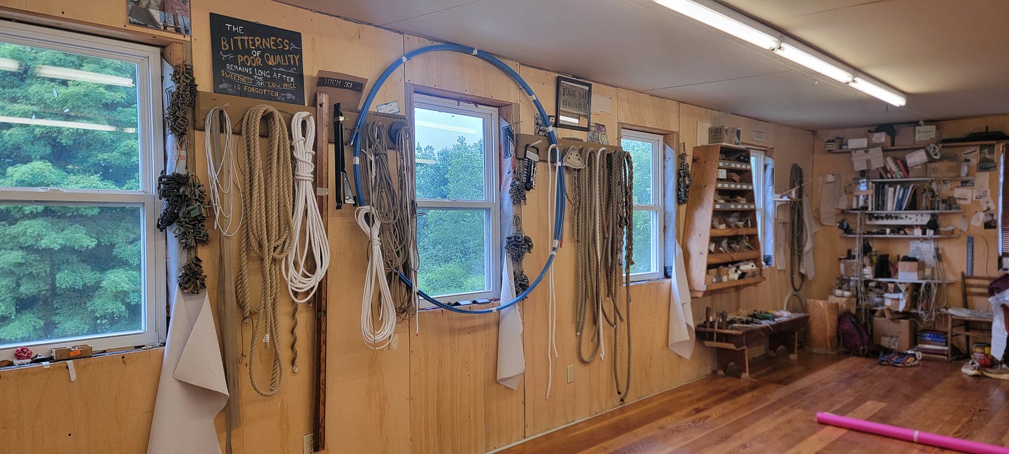A wood panel sailmaking workshop with ropes, and a diversity of tools on the walls. A wood panel sailmaking workshop with ropes, and a diversity of tools on the walls.