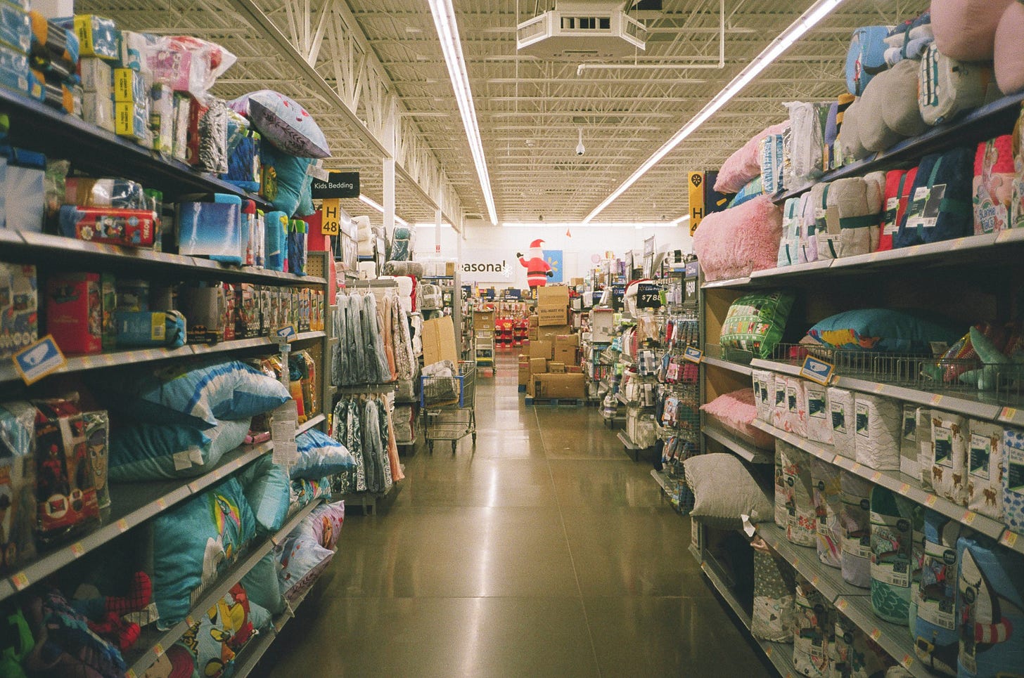 A sepia-toned photo of an aisle in a grocery store. 