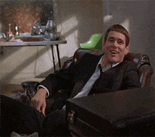 Movie gif. Jim Carrey as Lloyd in Dumb and Dumber sits back in a chair. He looks up at someone and awkwardly laughs and shrugs, looking around the room as he continues to shrug. Movie gif. Jim Carrey as Lloyd in Dumb and Dumber sits back in a chair. He looks up at someone and awkwardly laughs and shrugs, looking around the room as he continues to shrug.