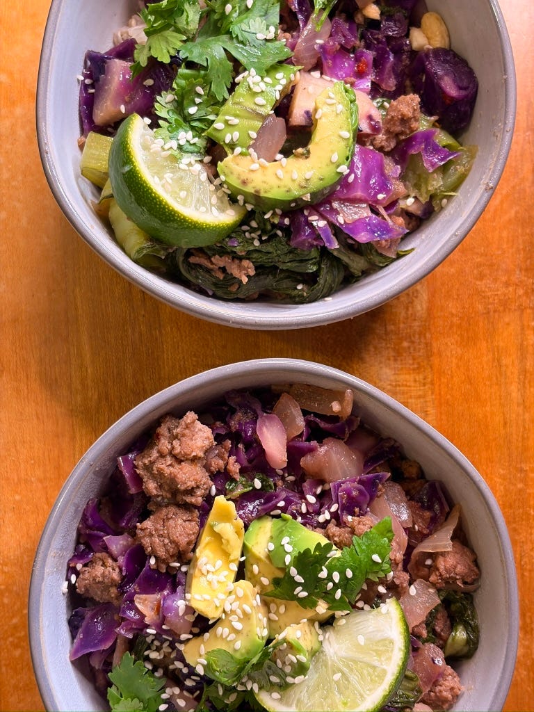 Beef & Bok choy stir fry in a bowl with avocado, cilantro, sesame seeds, and lime