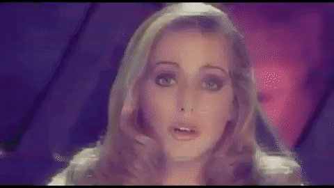 The blonde girl fills the screen, staticky and shaking on video.