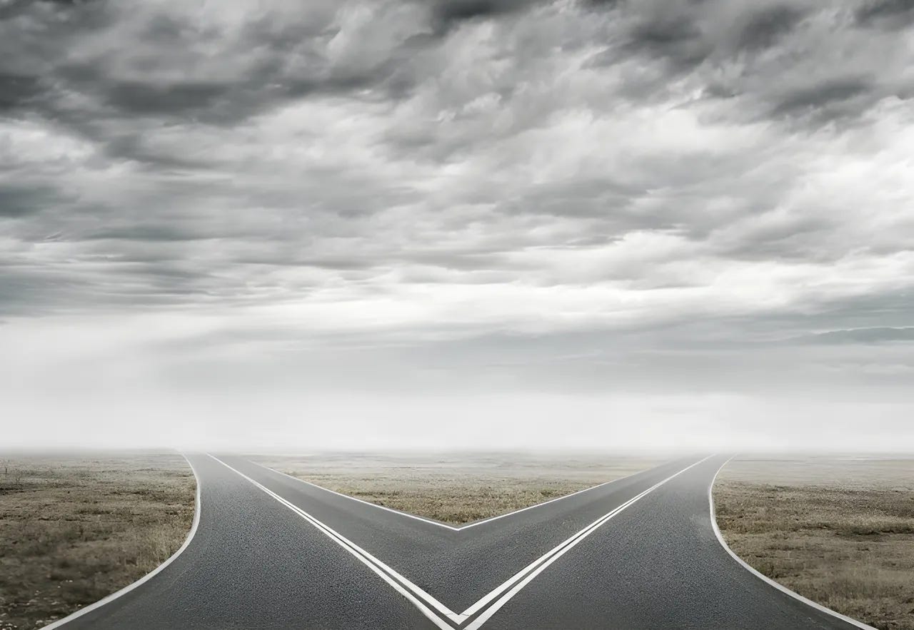 Two roads diverging into the horizon on a gray cloudy day. Two roads diverging into the horizon on a gray cloudy day.
