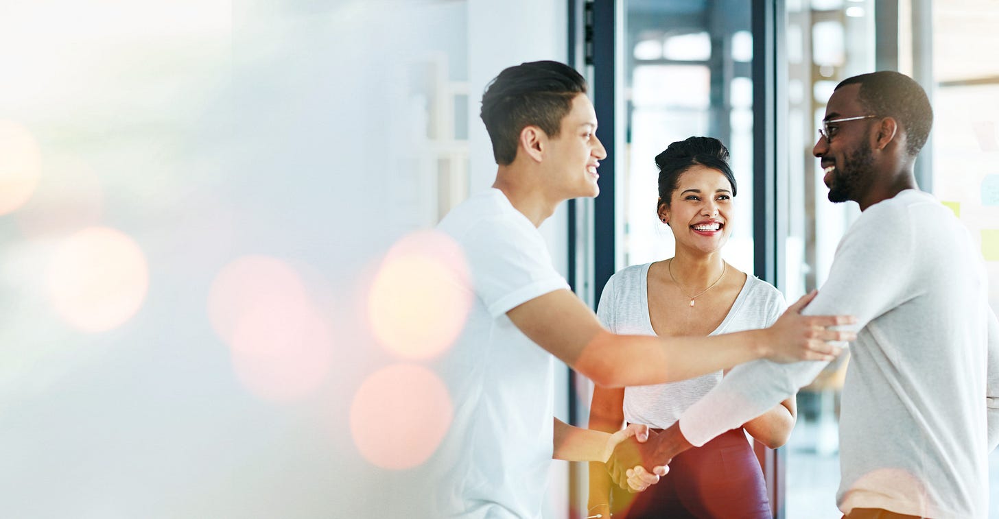 Successful job interview with three people smiling at each other