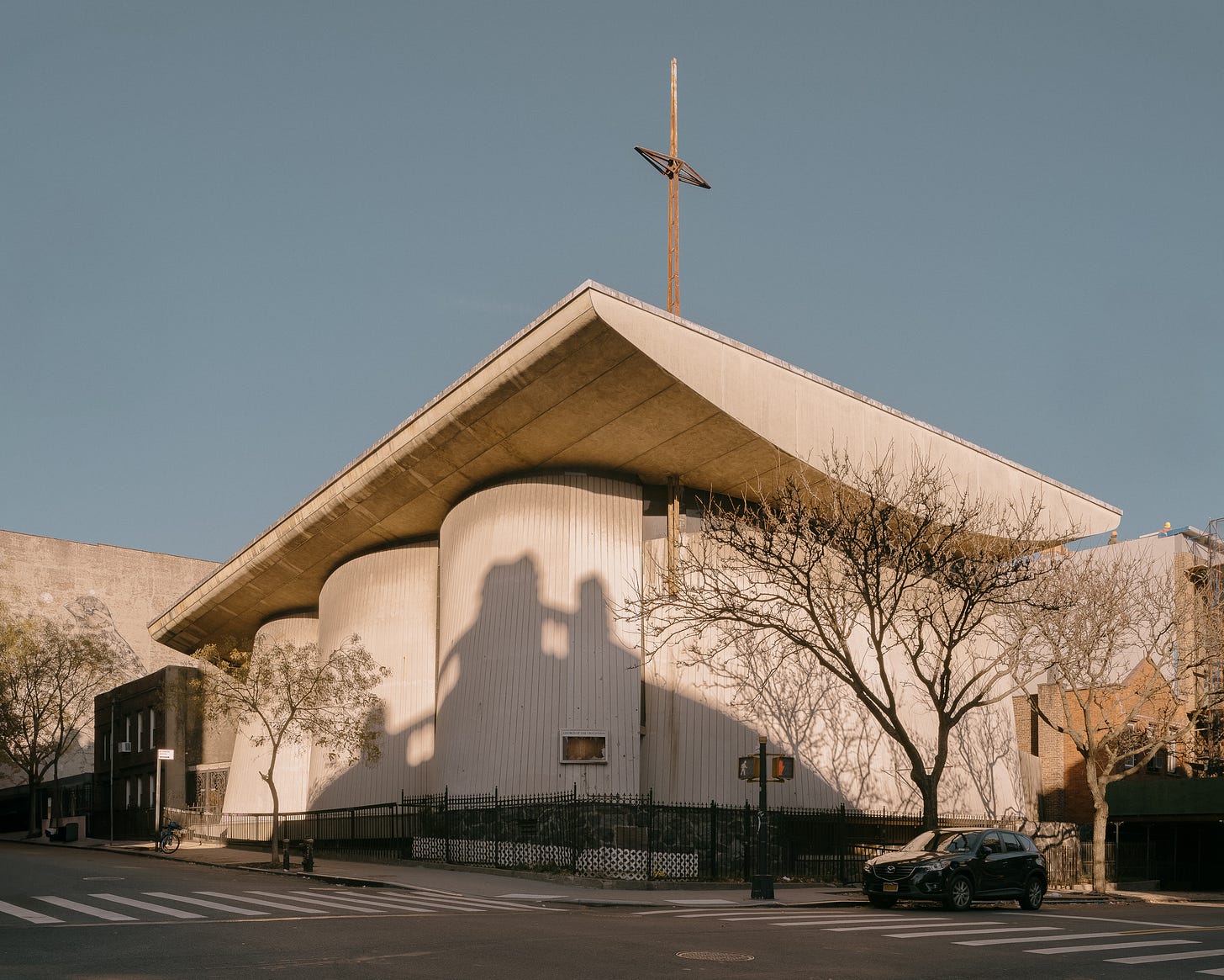 architectural image of a concrete church in brutalist style blue sky sunny day