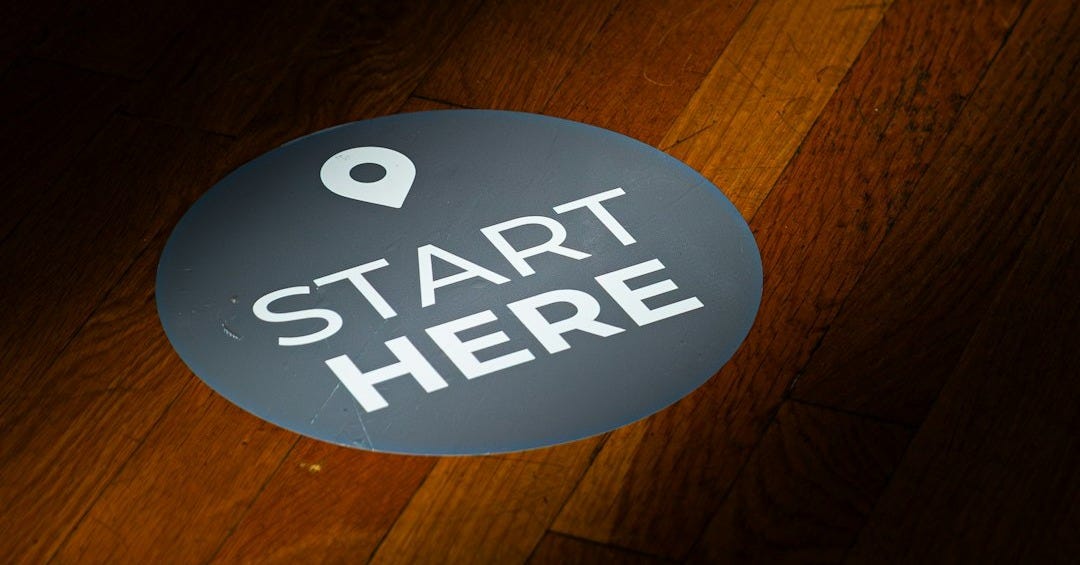 A round floor sticker with "start here" text A round floor sticker with "start here" text