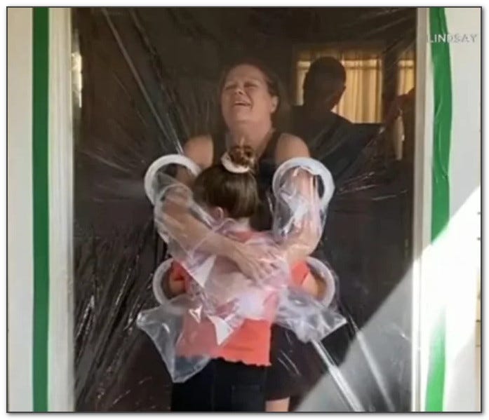 hugging child through plastic pandemic