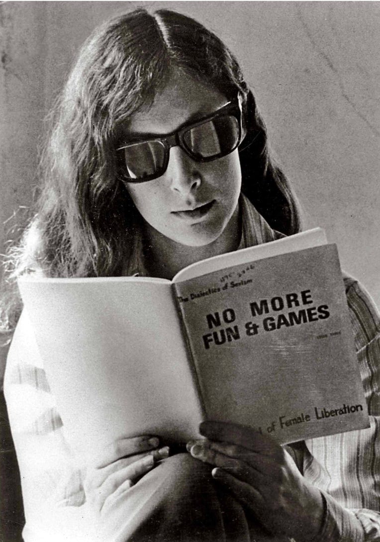 Ellen Willis, in sunglasses, reads a book called NO MORE FUN AND GAMES Ellen Willis, in sunglasses, reads a book called NO MORE FUN AND GAMES