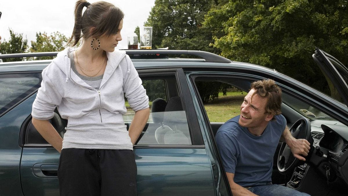 Katie Jarvis looks down at Michael Fassbender in "Fish Tank" (2009)