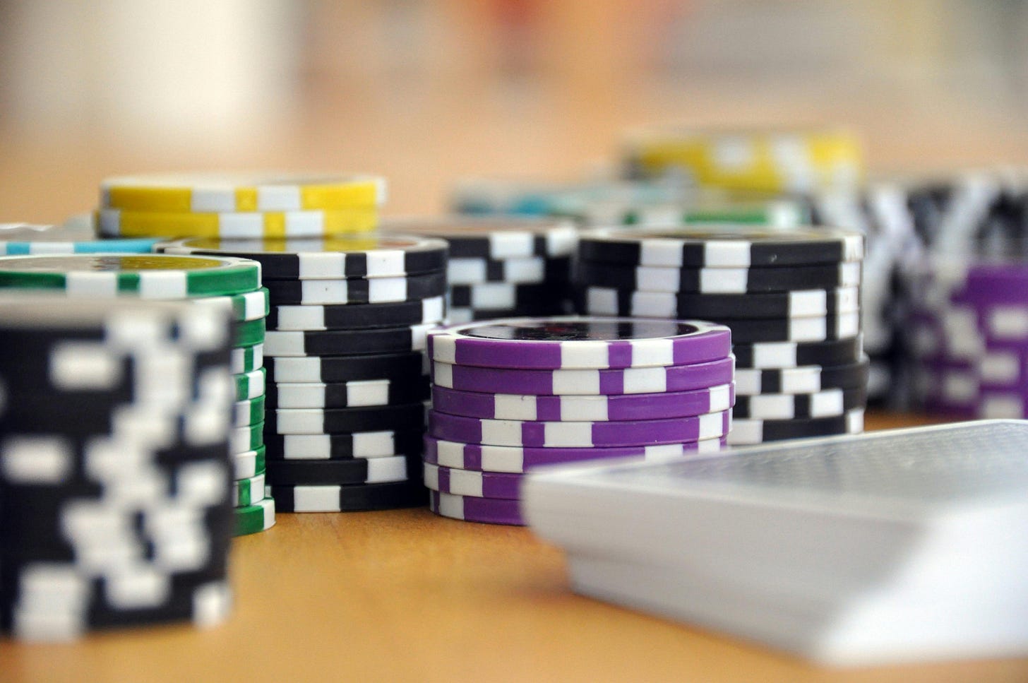 Poker chips stacked on a table symbolizing risk and betting, used as a metaphor for SaaS founders making growth projections. Poker chips stacked on a table symbolizing risk and betting, used as a metaphor for SaaS founders making growth projections.
