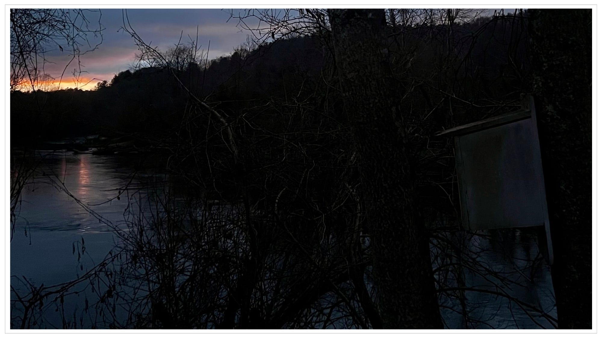 Pre-dawn light rising over river
