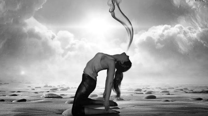 A grayscale conceptual image of a woman in a yoga pose on a rocky landscape, exhaling a plume of smoke toward a bright celestial light to represent the soul's detachment from the physical body.