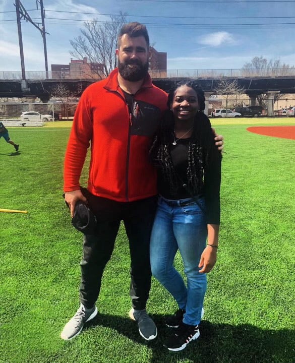 Boskett on a baseball field, posing with retired Eagles center, Jason Kelce