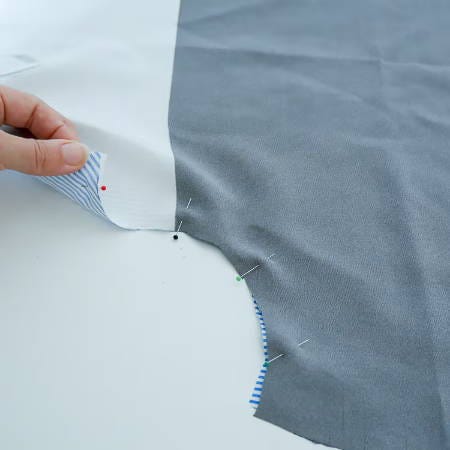 pin the two fabric pieces along the curved shape pin the two fabric pieces along the curved shape