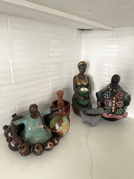 Ceramic figures and mortar and pestles on white marble counter