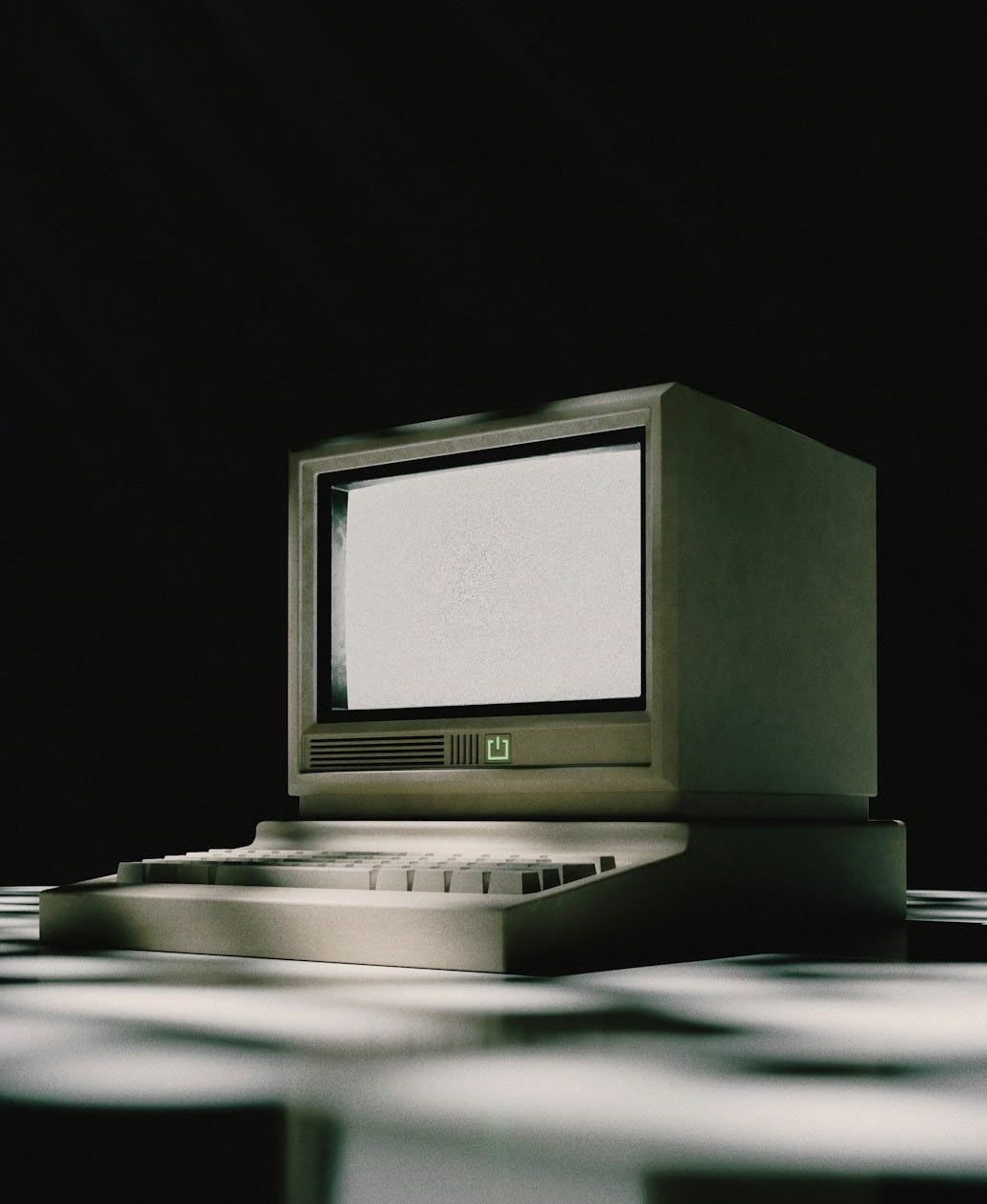A vintage computer sits on a patterned surface. A vintage computer sits on a patterned surface.