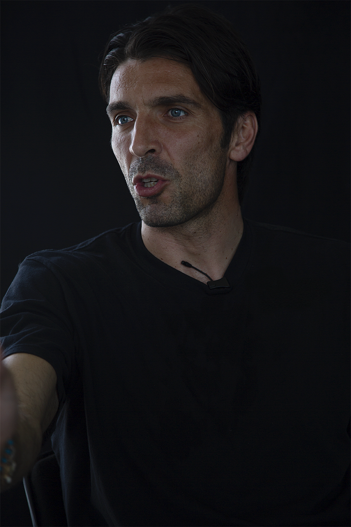 Gianluigi Buffon during an interview, shown in four portraits against a black background: smiling, speaking, in profile with a serious expression, and gesturing mid-sentence.