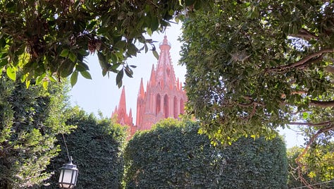 Jardín Principal, where locals gather and mariachis serenade and Parroquia de San Miguel Arcángel—its pink facade glowing in the evening light.