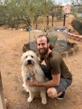 A person kneeling on the ground with a dog

AI-generated content may be incorrect.