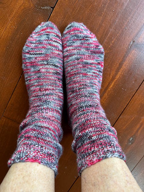 Baby quilt, knitted socks, and two knitted washcloths.