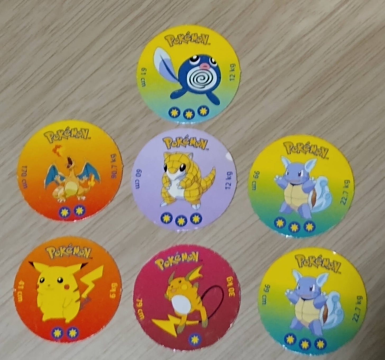 Battle Discs, cardboard discs similar to "Pogs" featureing Poliwag, Charizard, Sandshrew, Pikachu, Raichu, and two Wartortles Battle Discs, cardboard discs similar to "Pogs" featureing Poliwag, Charizard, Sandshrew, Pikachu, Raichu, and two Wartortles