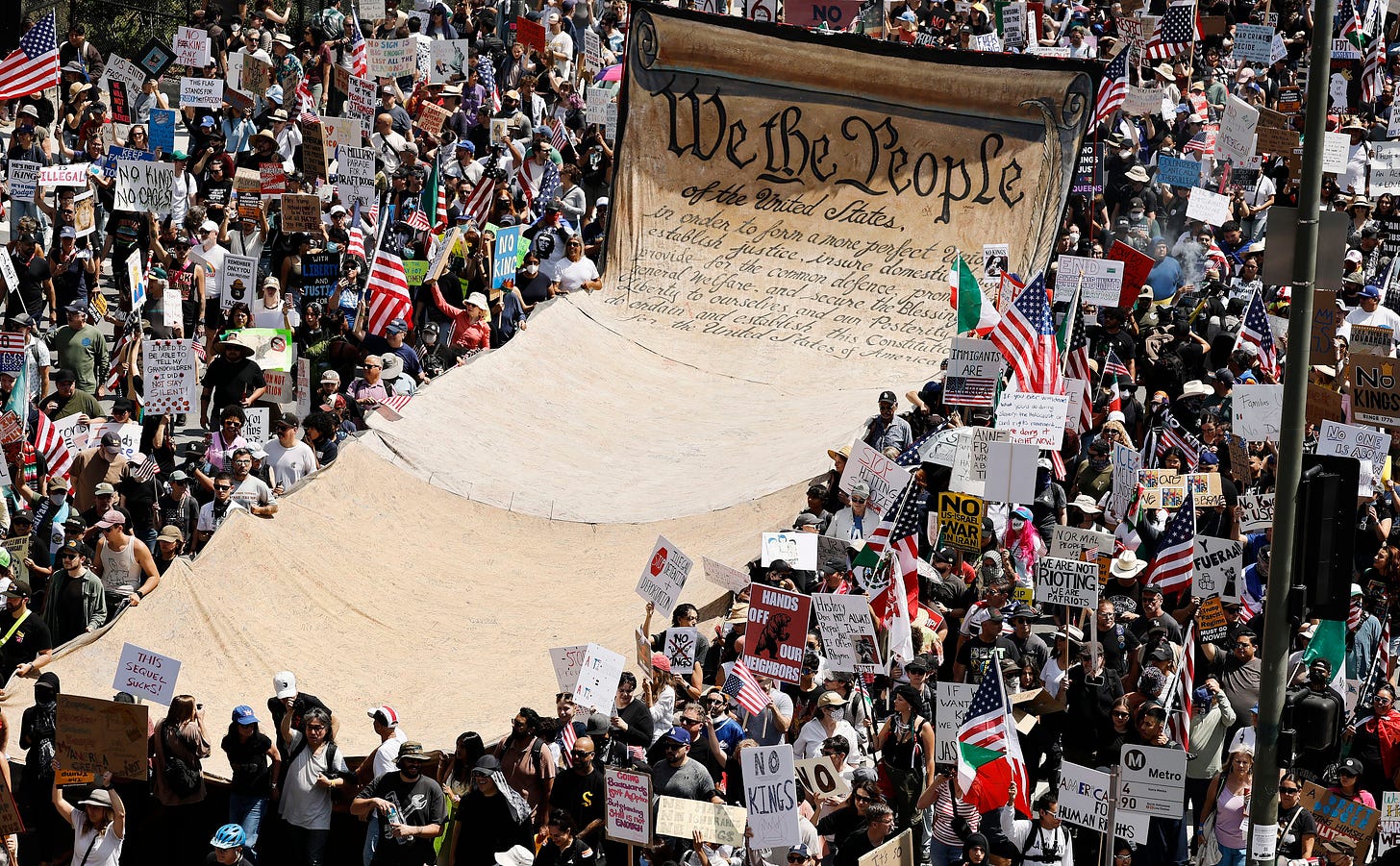Protesters in downtown Los Angeles carry a banner representing the Preamble to the US Constitution.