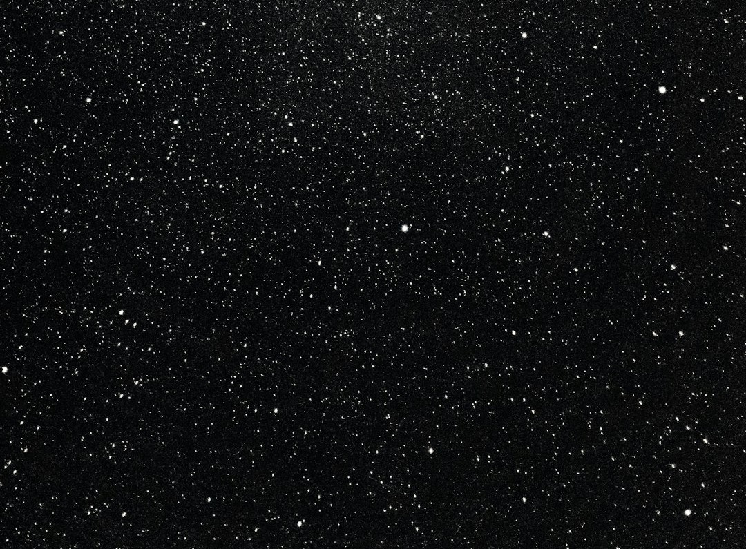 a black and white photo of the night sky