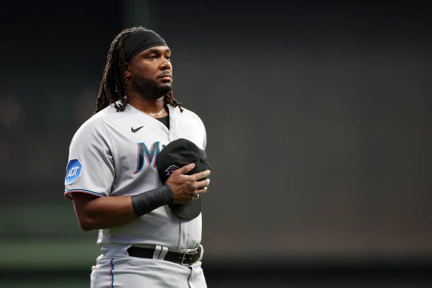 Josh Bell of the Miami Marlins stands for the National Anthem prior to a game against the Milwaukee Brewers at American Family Field on September 11,...