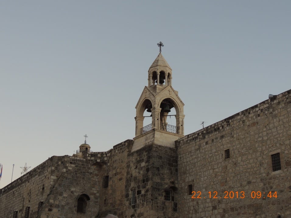A stone building with a bell tower

Description automatically generated