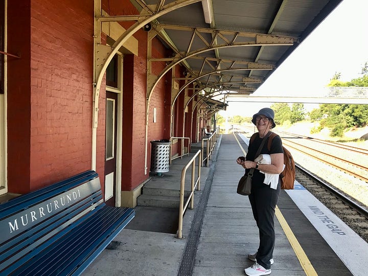 A woman at the station and a train timetable