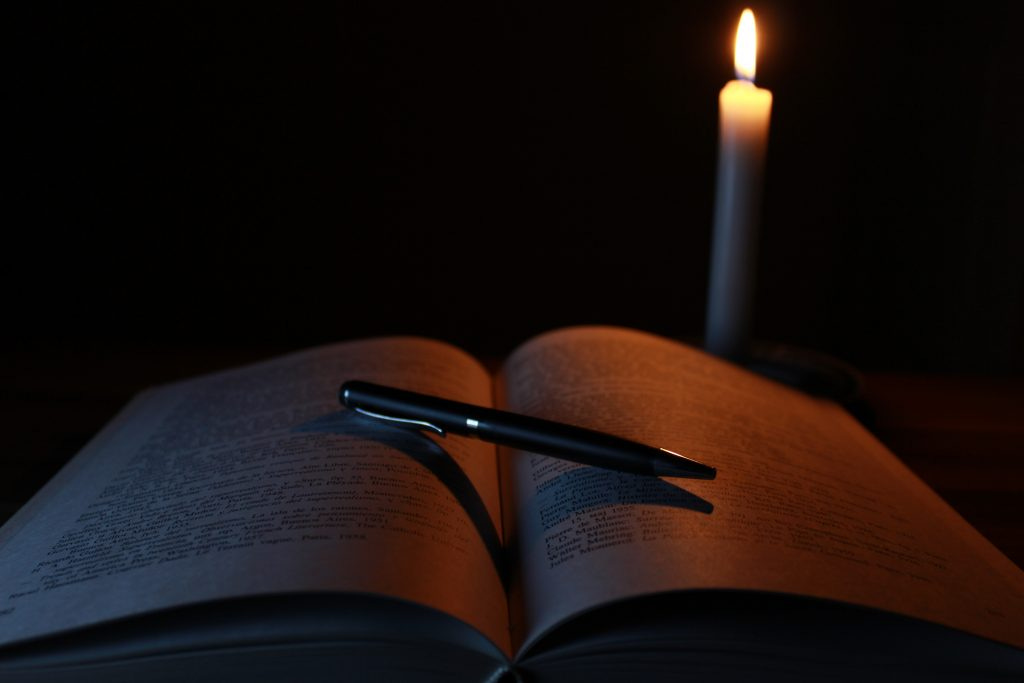 Why I Set New Moon Intentions; book, candle and pen