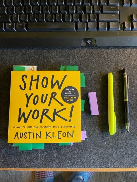A book with pages marked, along with a highlighter and pencil.