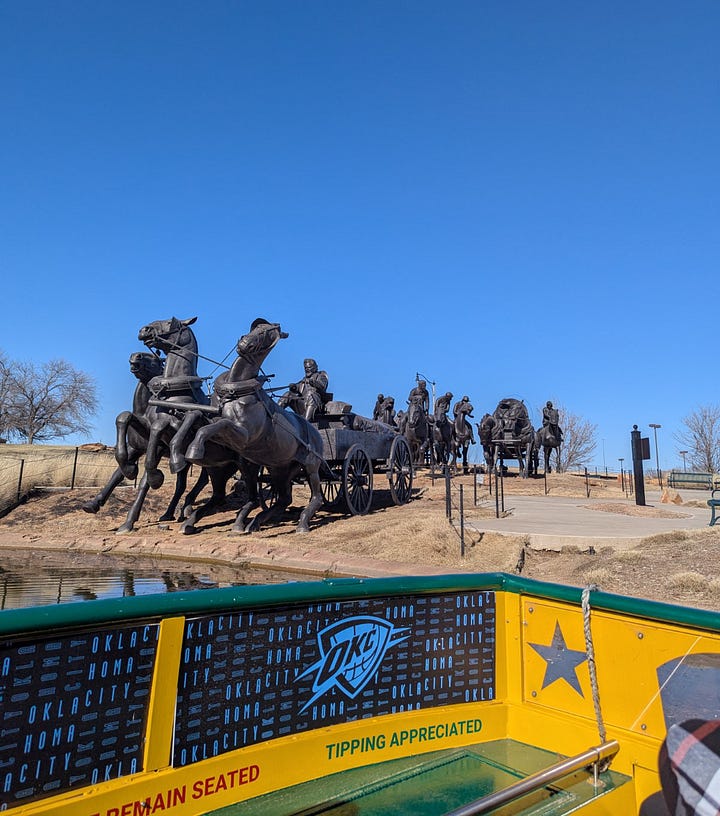 sculpture of Land Rush boomers and sooners, seen from water taxi