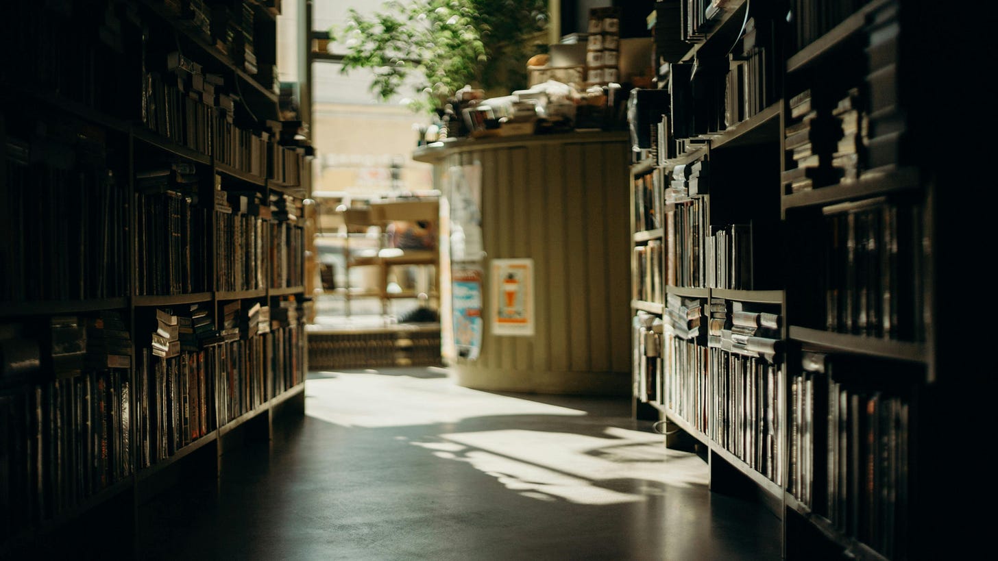 A dark library with light flooding in A dark library with light flooding in